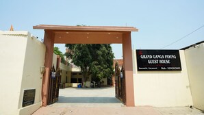 A gated entrance to a building with a sign for 'The Grand Ganga Paying Guest House' in Sarnath, Varanasi, including a contact number. - The Grand Ganga Paying Guest (VARANASI)