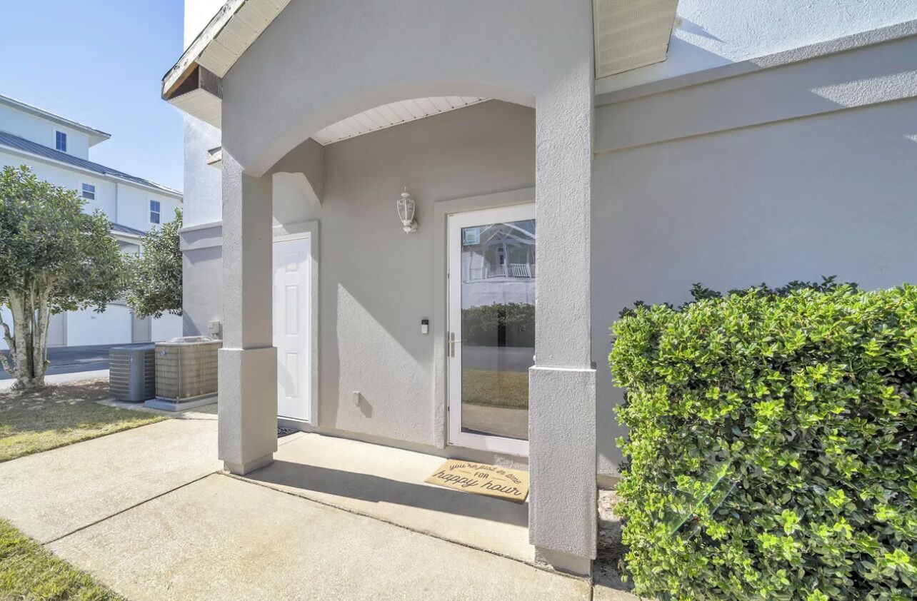 A building entrance with a covered porch, a door, and a small window.