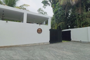 A gated entrance to a building with a sign that reads 'HARU AHANGAMA.'