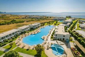 A resort with a large pool, multiple buildings, and a view of the sea. - Levante Athletic Resort (Rhodes)