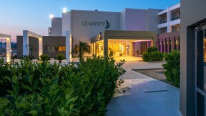 A LEVANTE hotel with a modern design, featuring a well-lit entrance and a landscaped outdoor area. - Levante Athletic Resort (Rhodes)