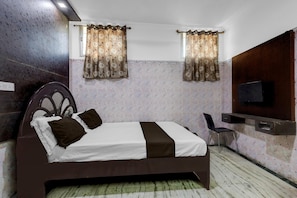 A bedroom with a bed, curtains, a TV, and a desk. - Hotel O Madipakkam Lakeview Chennai (Chennai)