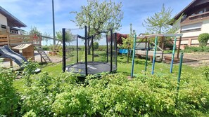 A playground with a trampoline, slide, and climbing structures. - "Panorama" Maisonette Apartment with 2 Balconies (Freiamt)