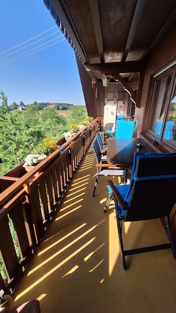 A balcony with a table, chairs, and a grill.. "Panorama" Maisonette Apartment with 2 Balconies