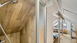 A room with a shower, wooden walls, a window, and a bed with a window view. - "Panorama" Maisonette Holiday Apartment with 2 Balconies (Freiamt)