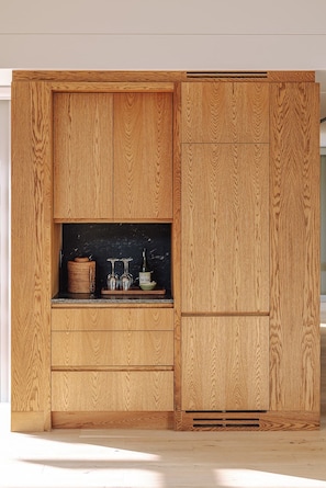 A wooden cabinet with a black countertop, a woven basket, and a glass container labeled 'TEA LEAF'. - Franschhoek Holiday Home for a family or friends traveling together (Franschhoek)