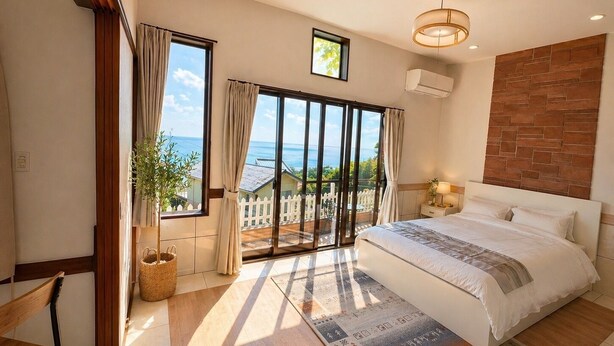 A bedroom with a large bed, a view of the sea, a balcony, and a wooden floor. - Peaceful Ocean View Villa with Free Parking & Full Kitchen (Miyazaki)