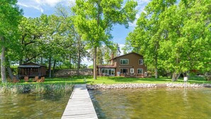 A wooden dock leading to a house with a pond, surrounded by trees. - Granite Lake Retreat w/ Private Dock (Annandale)