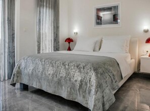 A modern bedroom with a bed, two bedside lamps, a window with curtains, and a framed picture on the wall. - Villa Antonija With Outdoor Pool (Imotski)