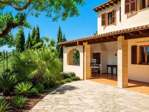 A two-story house with a stone pathway leading to a covered patio area. - Villa Sa Pleta - Three Bedroom Villa, Sleeps 6 (Mallorca)
