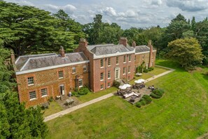 A large brick building with a courtyard and outdoor seating area.
