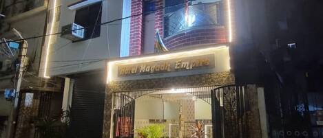 A building with a sign reading 'Hotel Magadh Empire.'