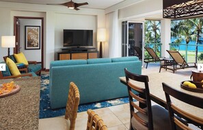 A living room with a sofa, chairs, a television, and a view of the outdoors. - Christmas Holiday Luxury in Marriott's Kauaʻi Lagoons Oceanfront Resort! (Lihue)