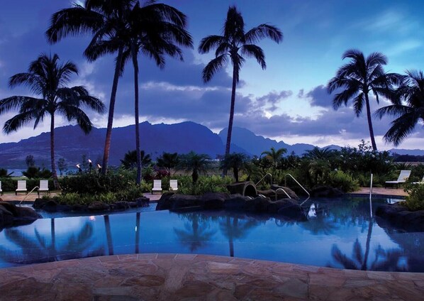 A pool with palm trees and a mountain view. - Christmas Holiday Luxury in Marriott's Kauaʻi Lagoons Oceanfront Resort! (Lihue)