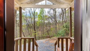 A wooden porch leading to a forested area with a gravel path. - Seclusion Retreat (Gatlinburg)