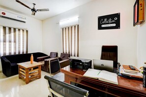 A room with a desk, chair, laptop, printer, and a couch. - Collection O Kelambakkam Chennai (Tirupporur)