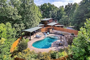 A two-story house with a swimming pool, surrounded by dense forest. - Eagles Perch Pool Cabin (Cosby)