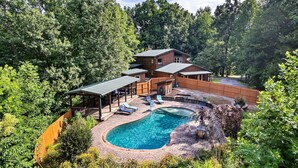 A two-story house with a swimming pool, surrounded by dense forest. - Eagles Perch Pool Cabin (Cosby)