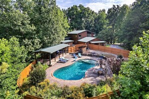 A two-story house with a swimming pool, surrounded by dense forest. - Eagles Perch Pool Cabin (Cosby)