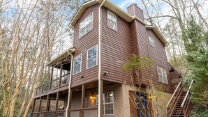 A two-story house with a balcony, a blue door, and a staircase. - Heavenly Sunshine (Gatlinburg)