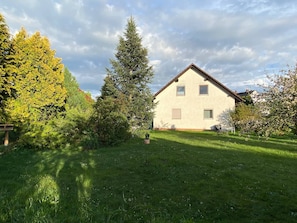 A single-story house with a sloped roof, a small front porch, and a well-maintained lawn.