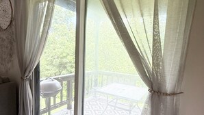 A room with a sliding glass door leading to an outdoor patio area. - Mountain Creek Condo Waterpark Ski Resort (Vernon Township)