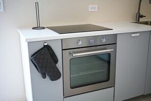 A kitchen with a built-in oven, a stovetop, and a countertop. - Lovely 1-bedroom apartment in charming Noord (Noord)