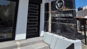 A modern building with a black and white facade, a prominent sign for 'VISTA PEDREGAL' with a logo, and a set of steps leading to the entrance. - Vista Pedregal Comfortable Apartment in Cabo San Lucas Golden Zone (Cabo San Lucas)