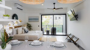 A modern bedroom with a bed, bedside table, and a view of a courtyard. - Vista Pedregal Comfortable Apartment in Cabo San Lucas Golden Zone (Cabo San Lucas)