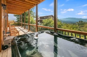 A hot tub on a wooden deck with a view of mountains. - Picadilly Perch (Gatlinburg)