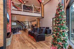 A spacious lobby with a Christmas tree, seating area, and a staircase leading to an upper level. - Waterfalls and Wildflowers (Gatlinburg)