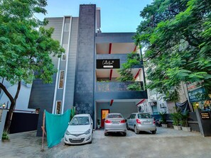 A modern building with a sign reading 'Collection' and a car parked in front. - Townhouse Oak T Nagar Chennai (Chennai)