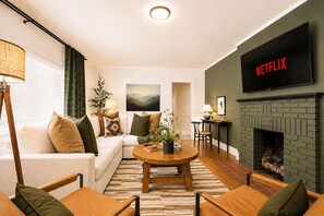 Twelve people under one roof, and it still somehow feels easy, the cozy sectional filling up while the post-hike recap slides into one more episode nobody quite remembers agreeing to.
