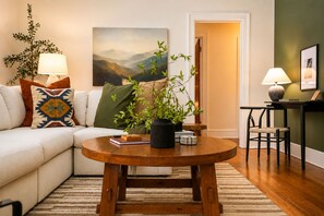 The house gives you room to be together and a corner to slip away to, the sectional pulling everyone in while the desk waits for whoever needs ten minutes to themselves.