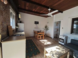 A compact living space with a kitchen, dining area, and seating area.