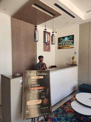 A pottery workshop sign with details on activities and included items. - CHERRY TREE (Greater Noida)
