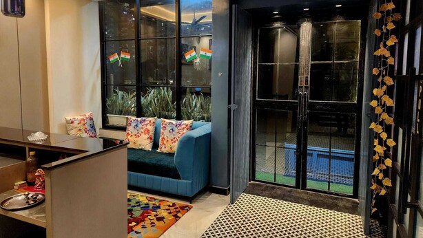 A modern living room with a sofa, a coffee table, and a patterned rug. - CHERRY TREE (Greater Noida)