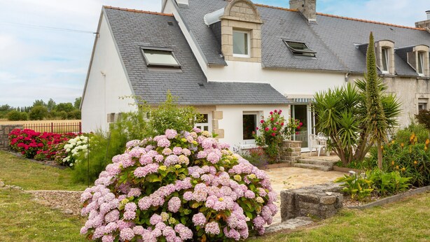 A house with a sloped roof, a chimney, and a small attached garage. - Bed and Breakfast 'Une Chambre À Lestriguiou' with Private Terrace, Private Garden and Wi-Fi (Plomeur)