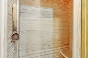 A wooden interior with a door and a small step leading to a lower level.