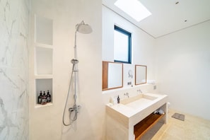 A modern bathroom with a shower, two sinks, and a skylight. - Karma 3 Villa (Badung)