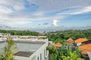A residential area with modern buildings, a clear sky, and a distant view of the sea. - Karma 3 Villa (Badung)