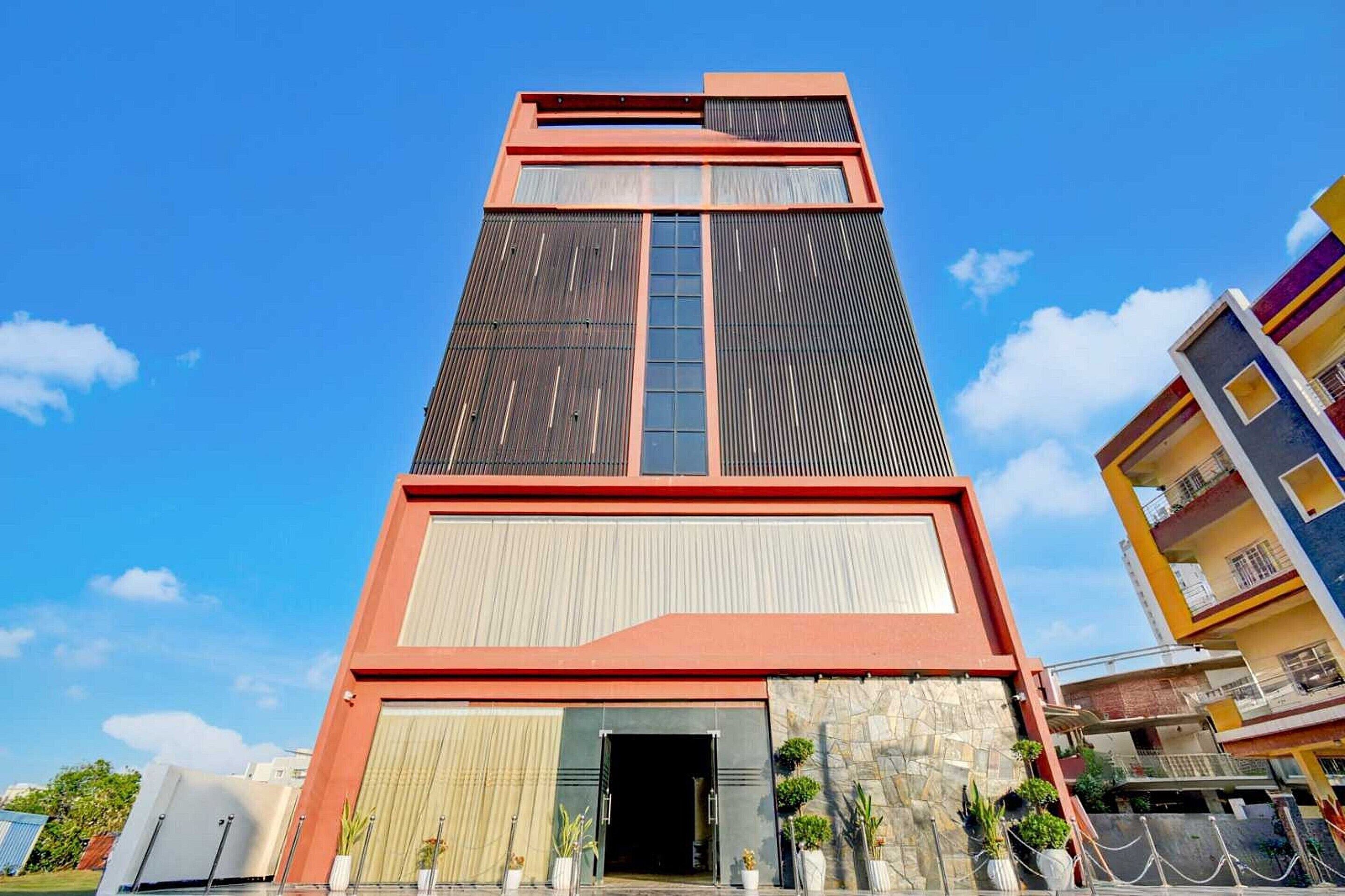 A multi-story building with a prominent entrance, large windows, and a modern architectural design.