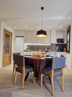 A modern kitchen with a dining area.