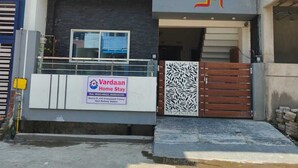 A modern two-story building with a visible sign for 'Vardaan Home Stay' and a gated entrance. - Vardaan Homestay  (Ujjain)