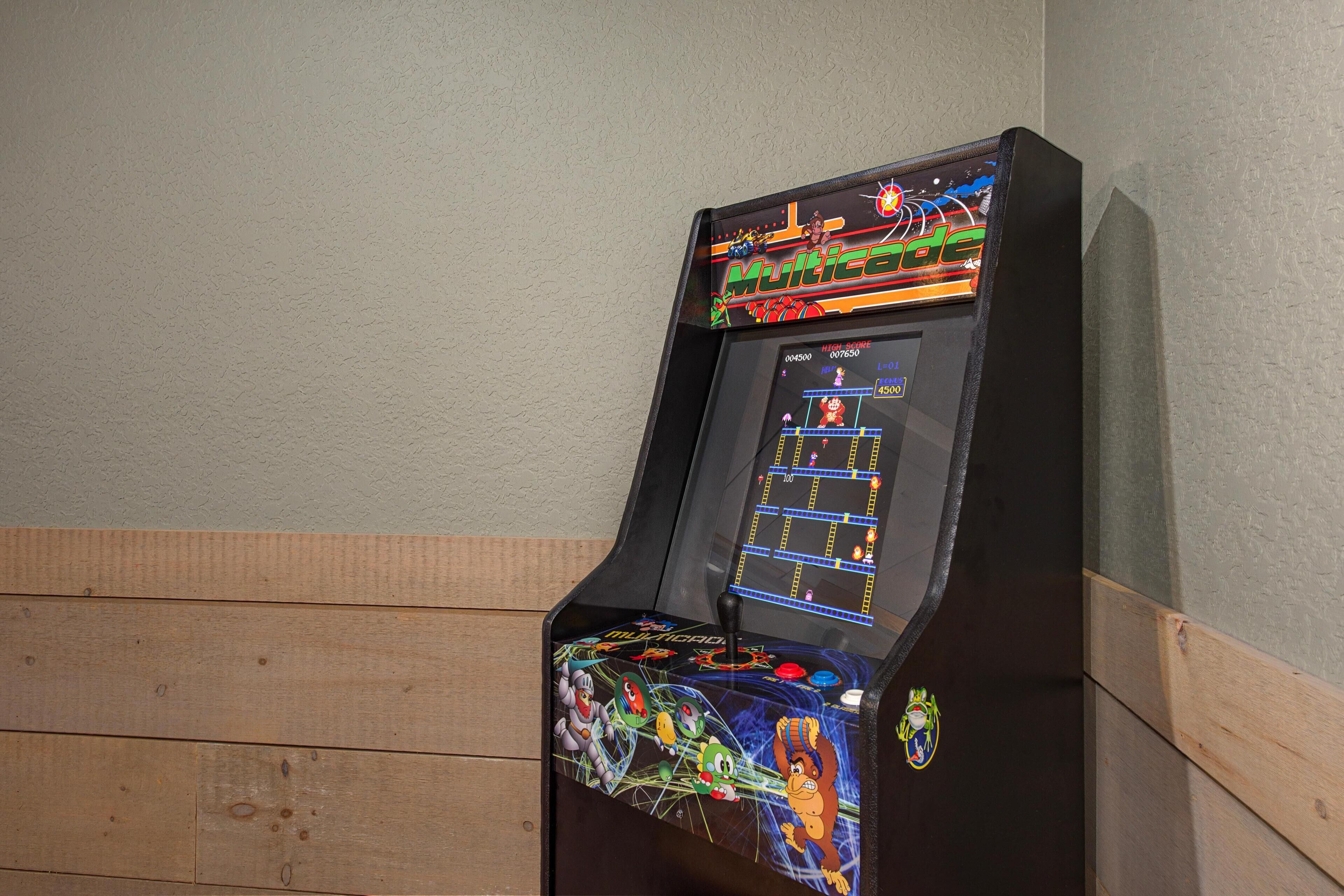 A video game arcade machine with a colorful display and joystick.