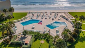 A resort with two swimming pools, a beach, and a view of the ocean. - Updated Oceanview Retreat With Pools, Pickleball & Direct Beach Access (New Smyrna Beach)