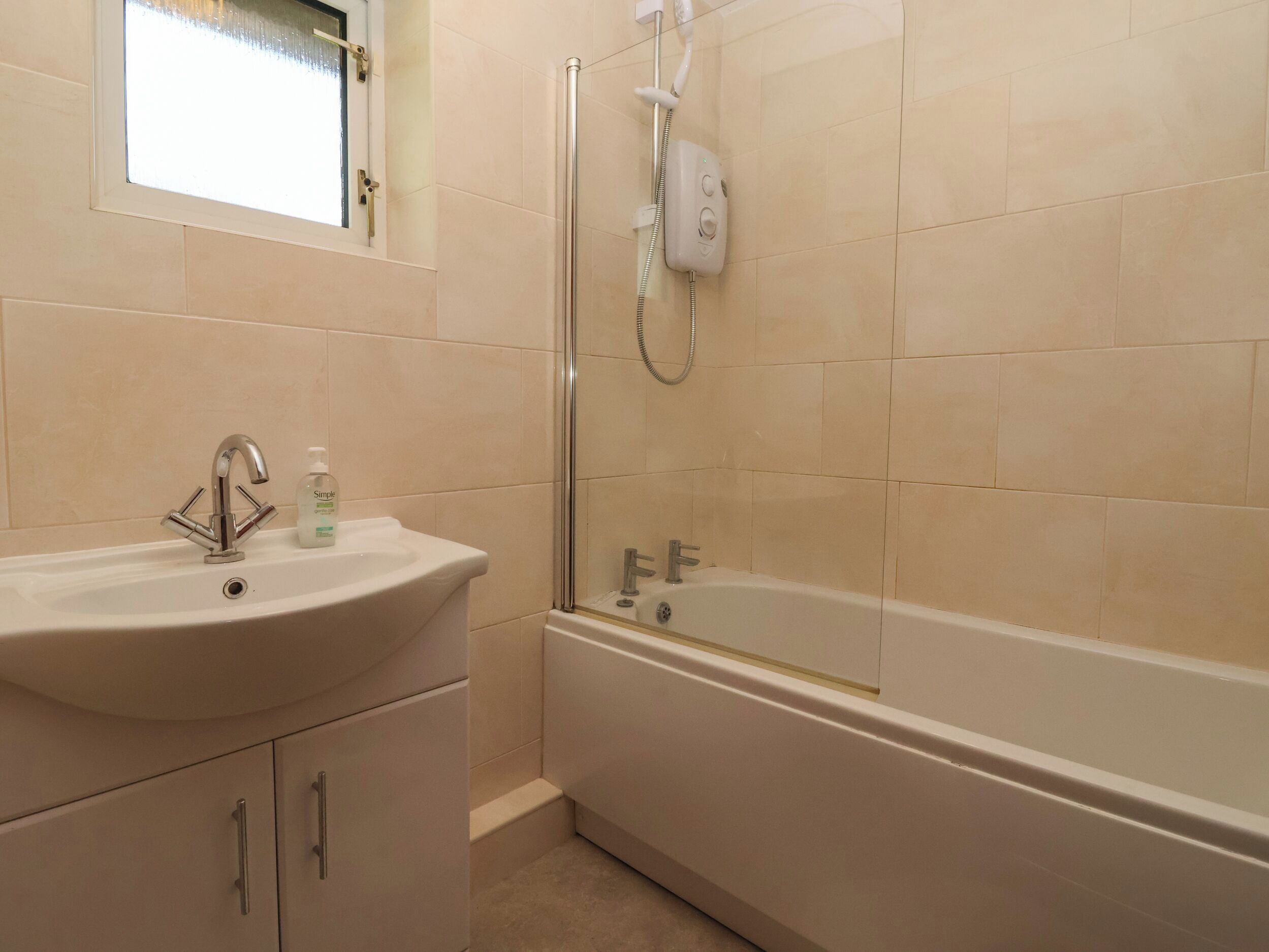 A bathroom with a sink, a bathtub, and a shower.