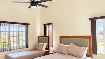Bright Studio 2 with a queen bed, single bed, vaulted ceiling and ceiling fan.