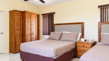 A bedroom with a bed, a nightstand, a wardrobe, and a ceiling fan.