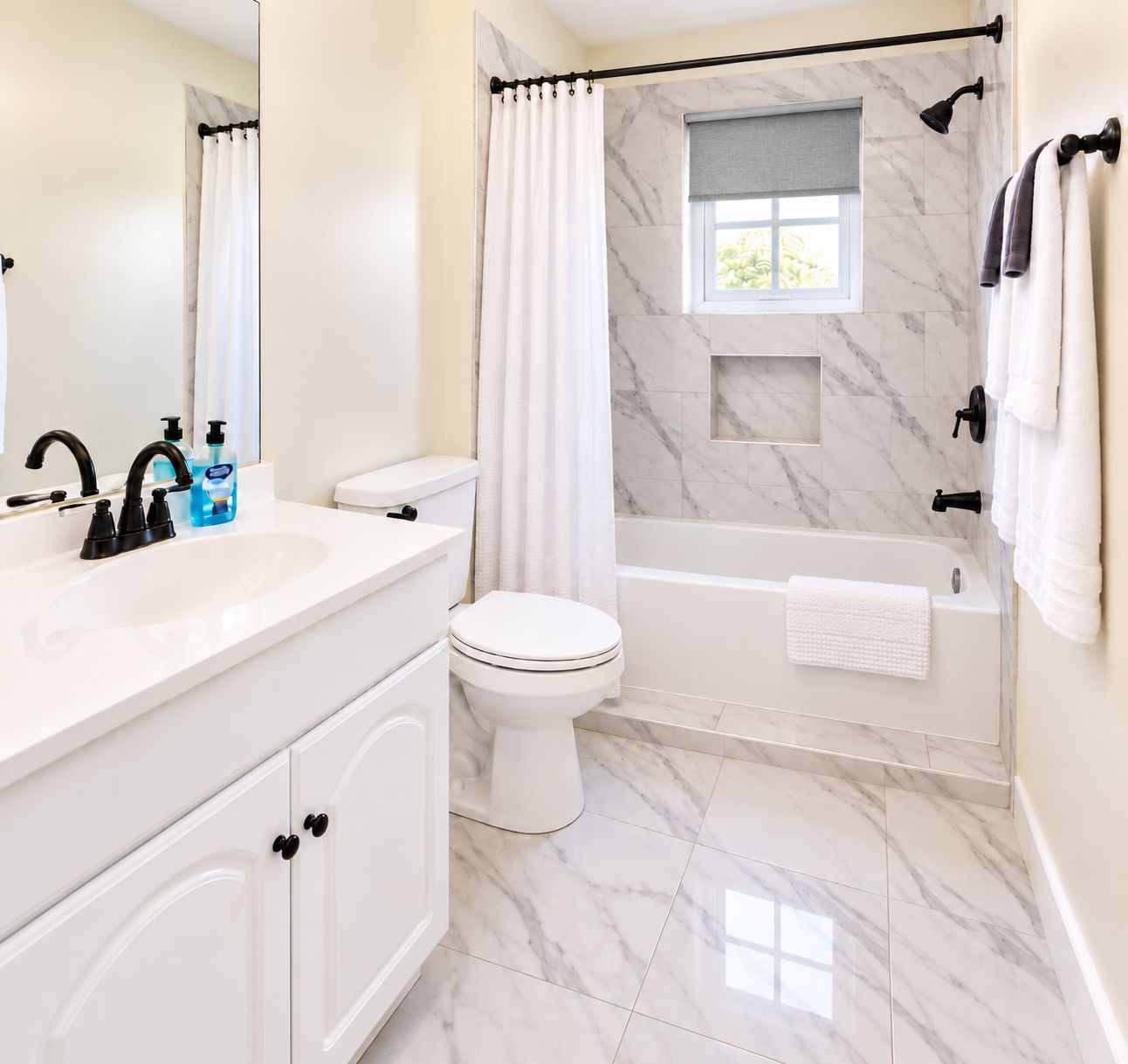A bathroom with a white sink, toilet, and bathtub.